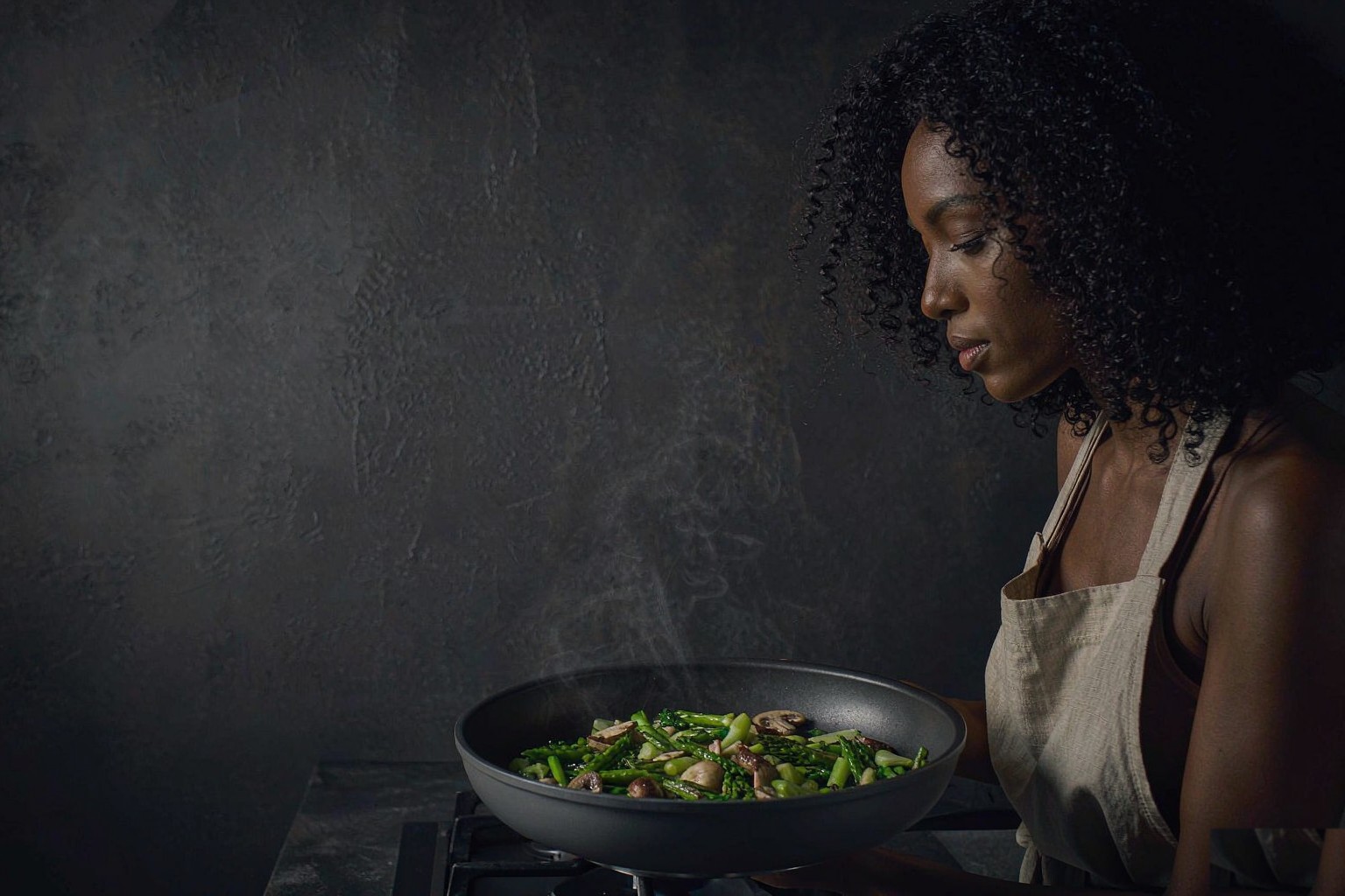 Cook searing vegetables in a Martholm charcoal skillet